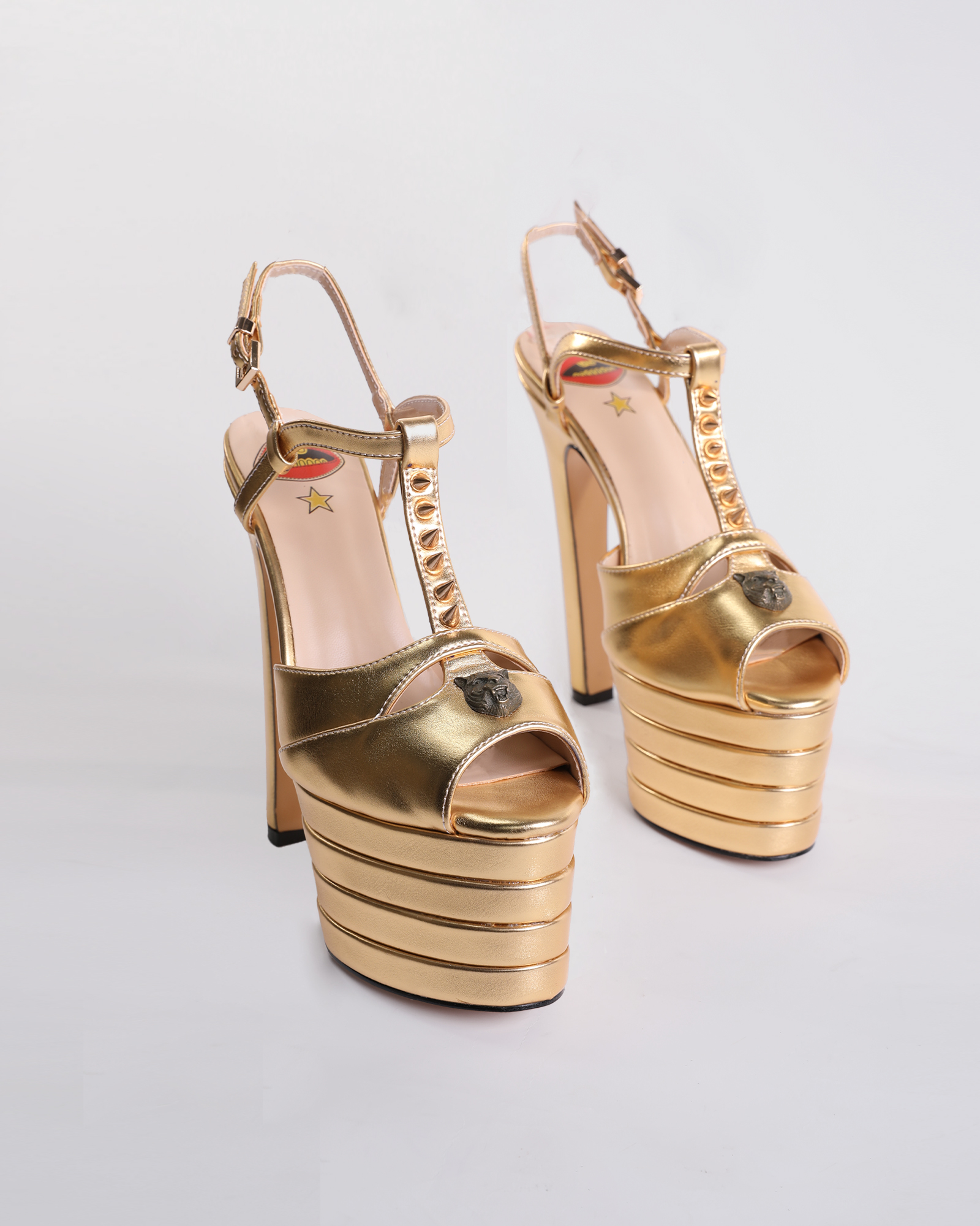 Dionisia Rivet Strap Platform Heels In Gold