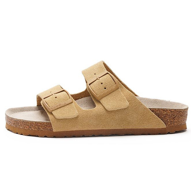 Women's sandals featuring a contoured cork sole that molds to the foot, with an adjustable double-buckle design.