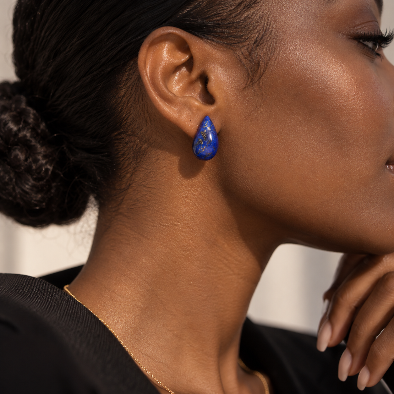 Riverstone teardrop stud shown in profile on the ear, showing how the stone sits against the lobe