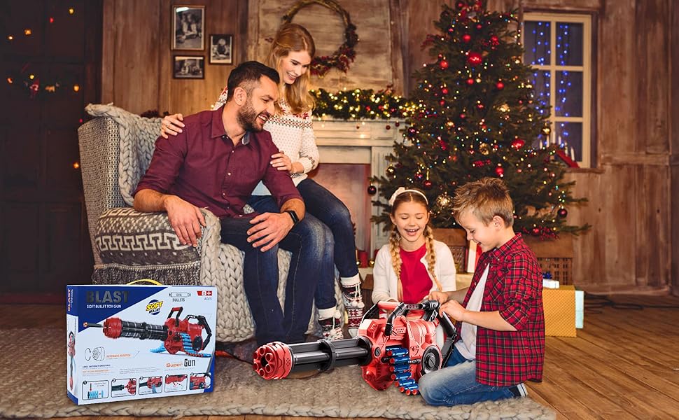 Family in living room with Christmas tree. Children playing with remote-controlled toy on floor. Product box visible with 'DOUBLE E' branding.