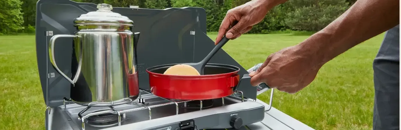 coleman stoves yard grass field tea kettle pancake breakfast camping tailgate party family cooking
