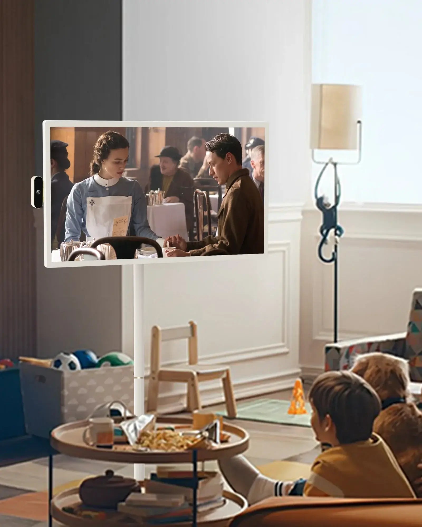Apolosign 32" smart TV on stand in living room with kids and dogs, displaying historical drama scene.