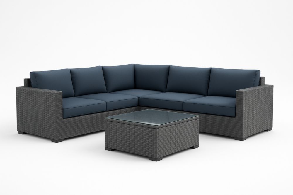 Set salotto angolare in rattan sintetico grigio con cuscini blu e tavolino in vetro temperato