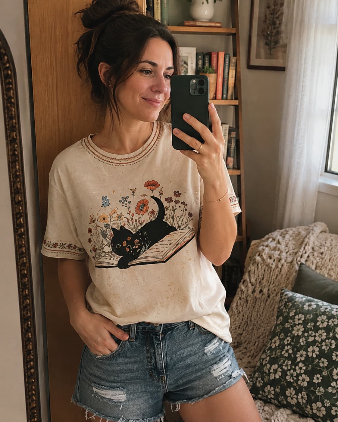 Hannah wearing the floral black cat and book T-shirt