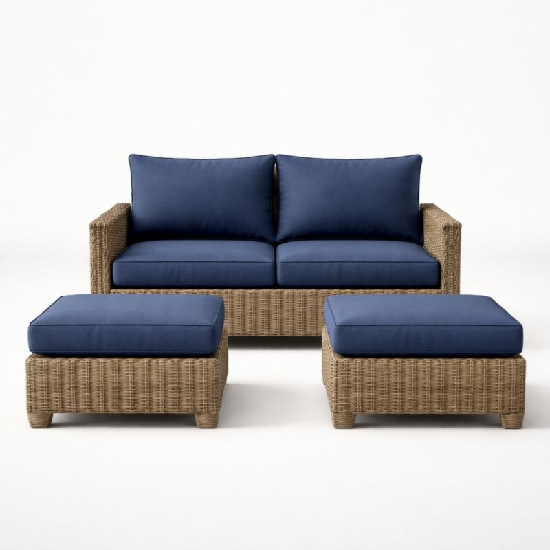 Canapé en rotin synthétique avec coussins bleus et deux repose-pieds