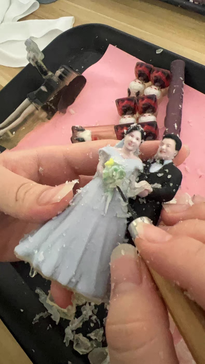 Behind-the-scenes bride and groom cake topper in progress