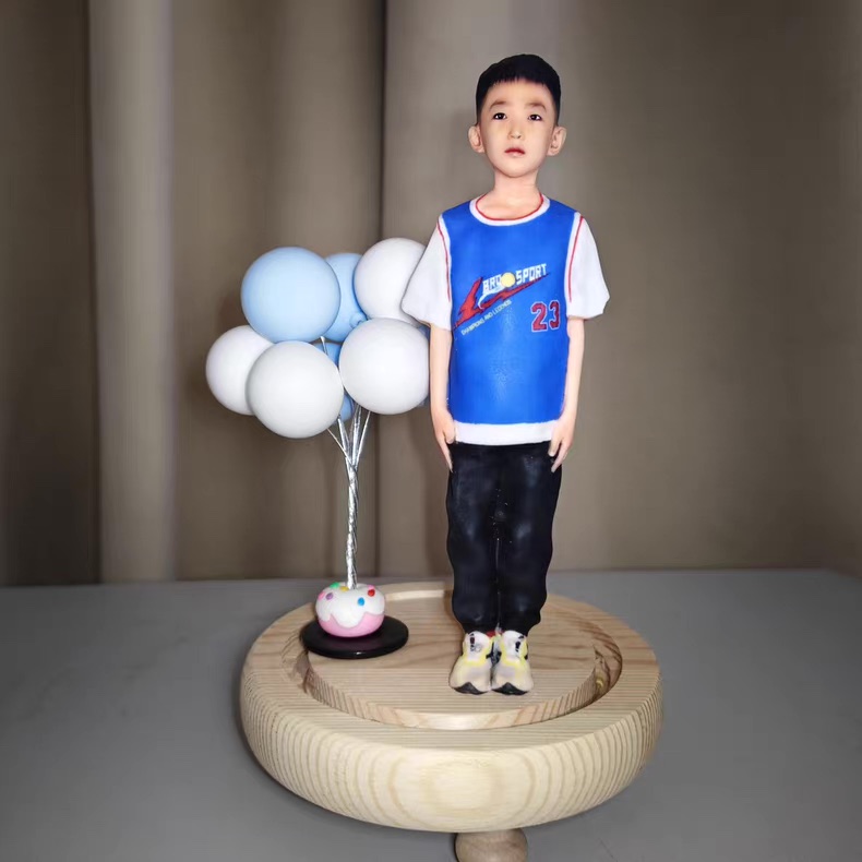 Finished figurine held in hand for close-up display