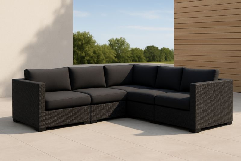 Divano ad angolo modulare da esterno in rattan con cuscini in poliestere nero