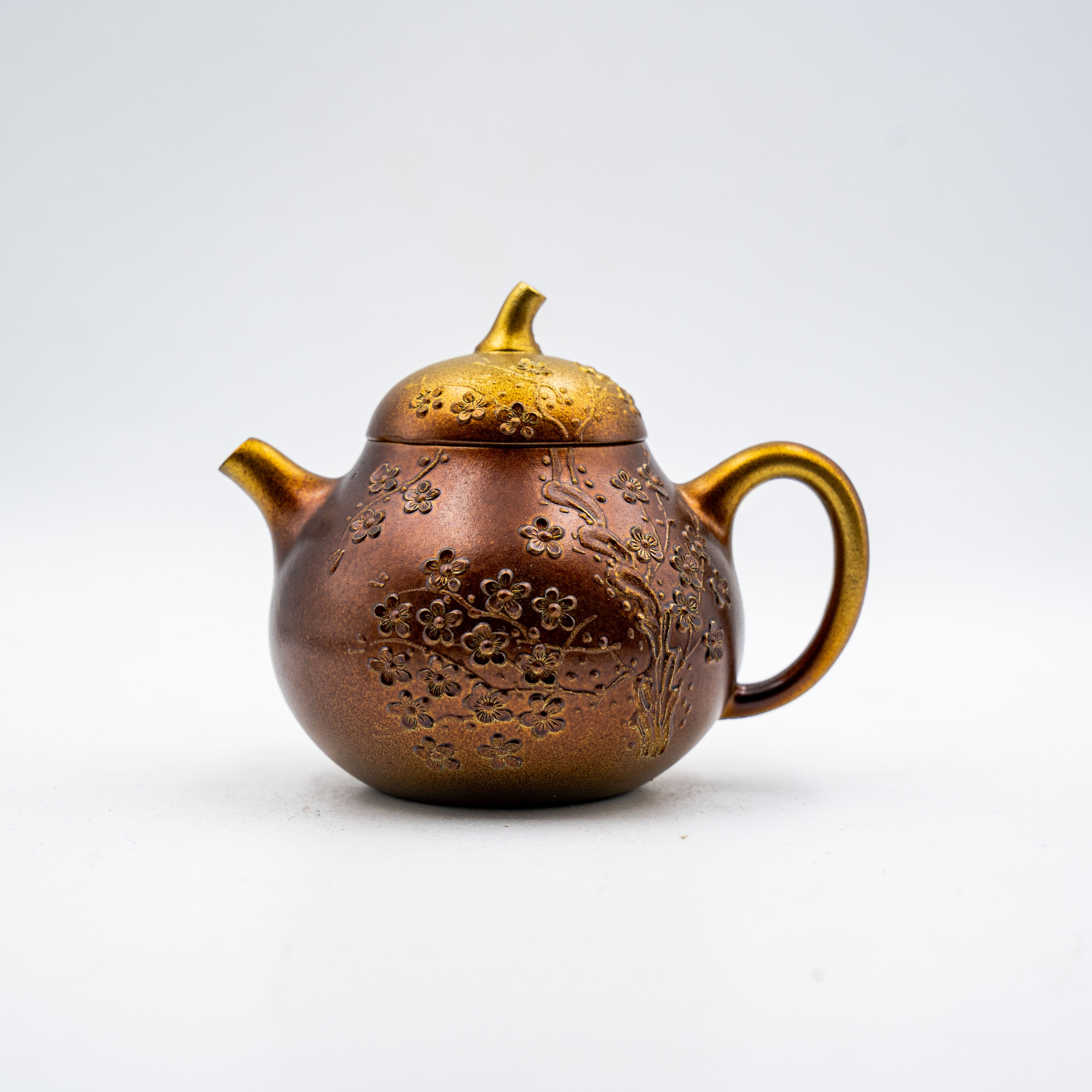 Handcrafted Yixing Longxue Sand Qieguo Teapot with Carved Plum Blossom Design