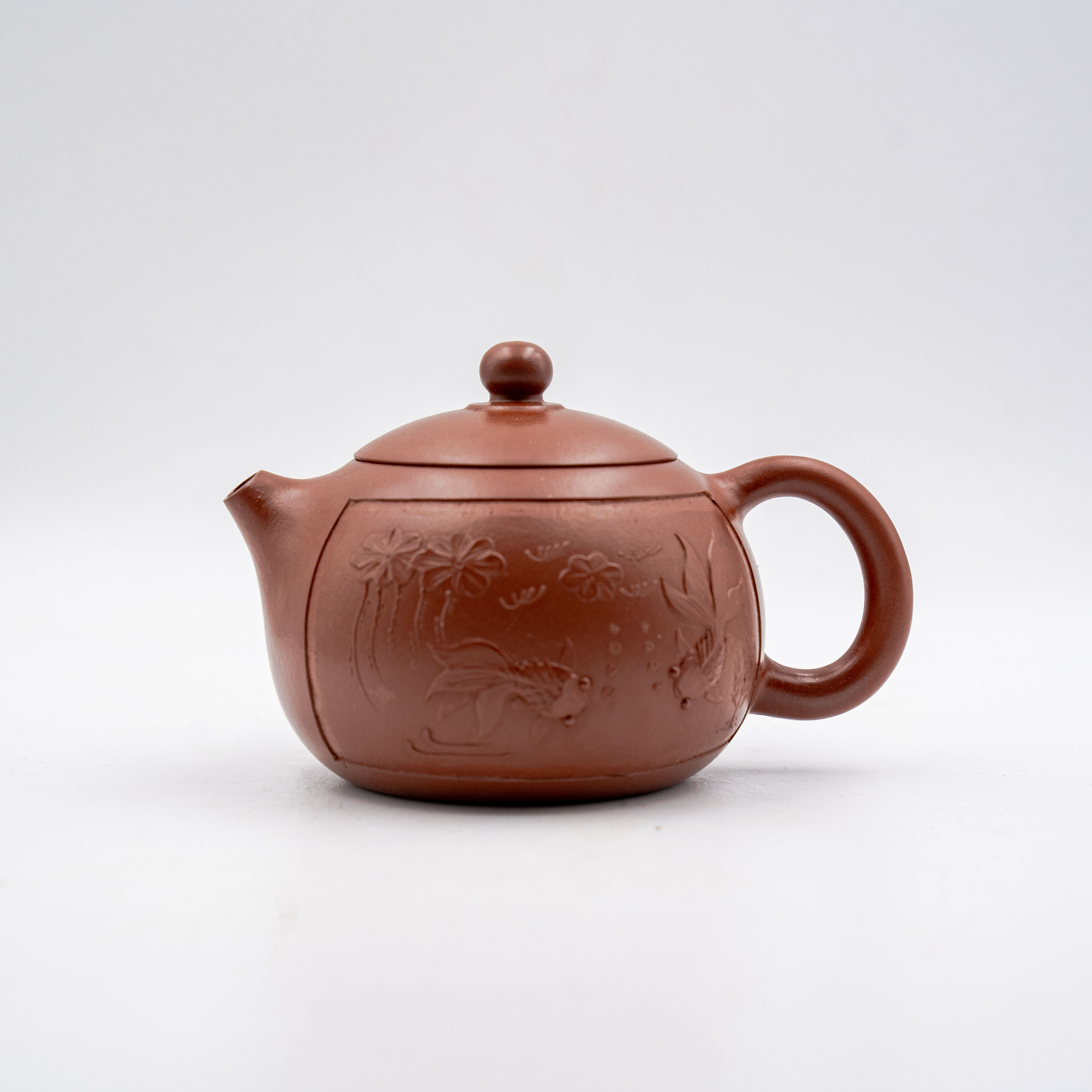 Handcrafted Yixing Red Clay Xishi Teapot with Carved Floral and Fish Design