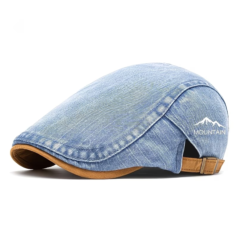 Blue men's denim-look flat cap showing mountain embroidery, contrast trim and metal rear closure