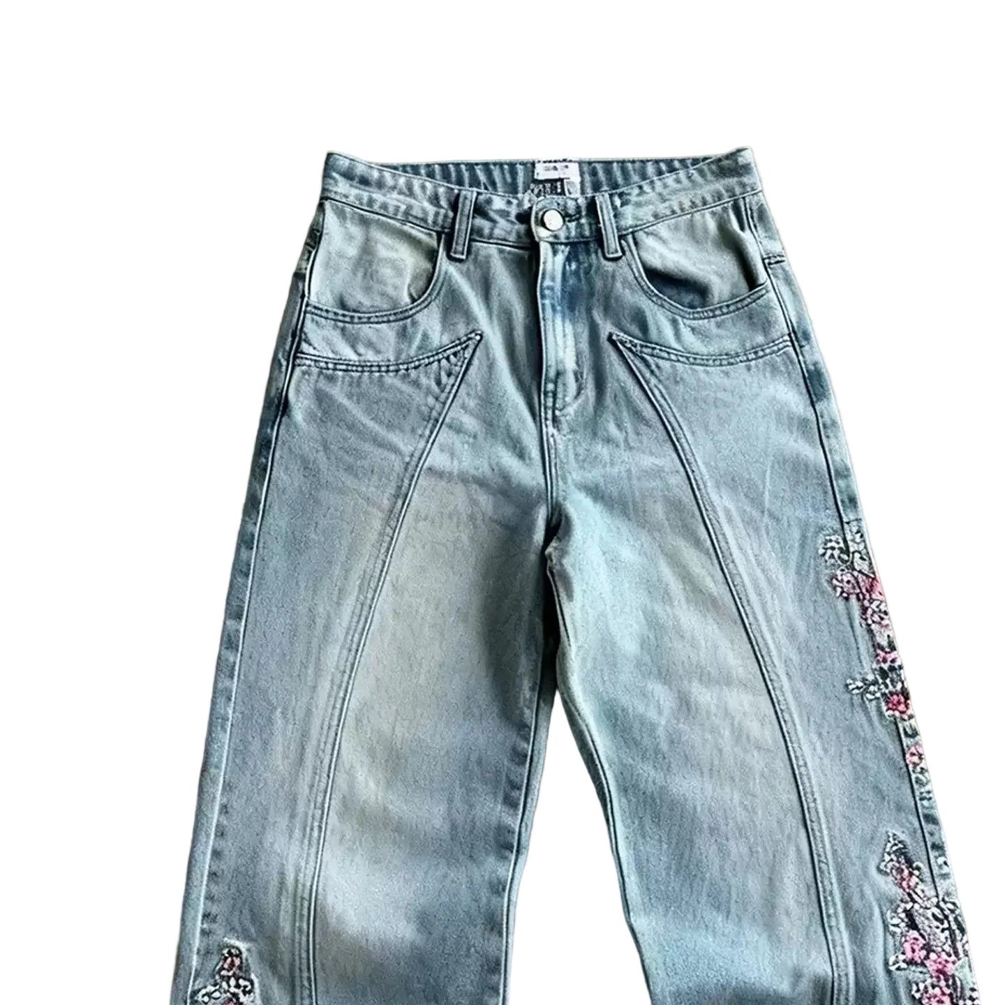 Light blue jeans with floral embroidery on a brown surface
