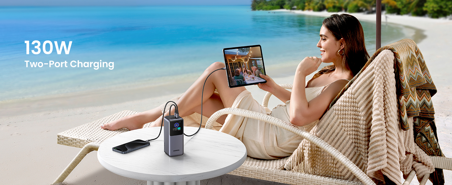 Beach Scene with Woman Charging Tablet and Phone via UGREEN Nexode Power Bank 20000mAh 130W Two-Port Charging Feature