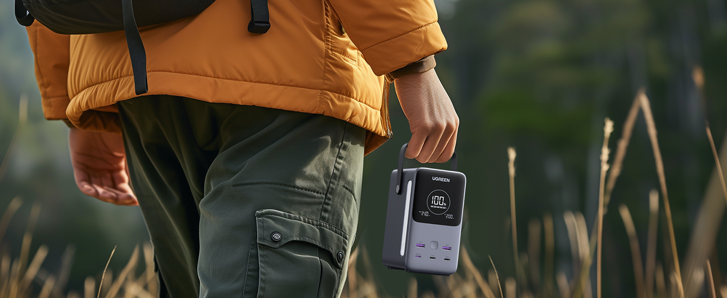 Person Holding UGREEN 300W 48000mAh Power Bank  in Outdoor Setting