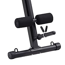 Black fitness equipment with adjustable arms, cushioned pads, and a sturdy base, likely for core or abdominal exercises.