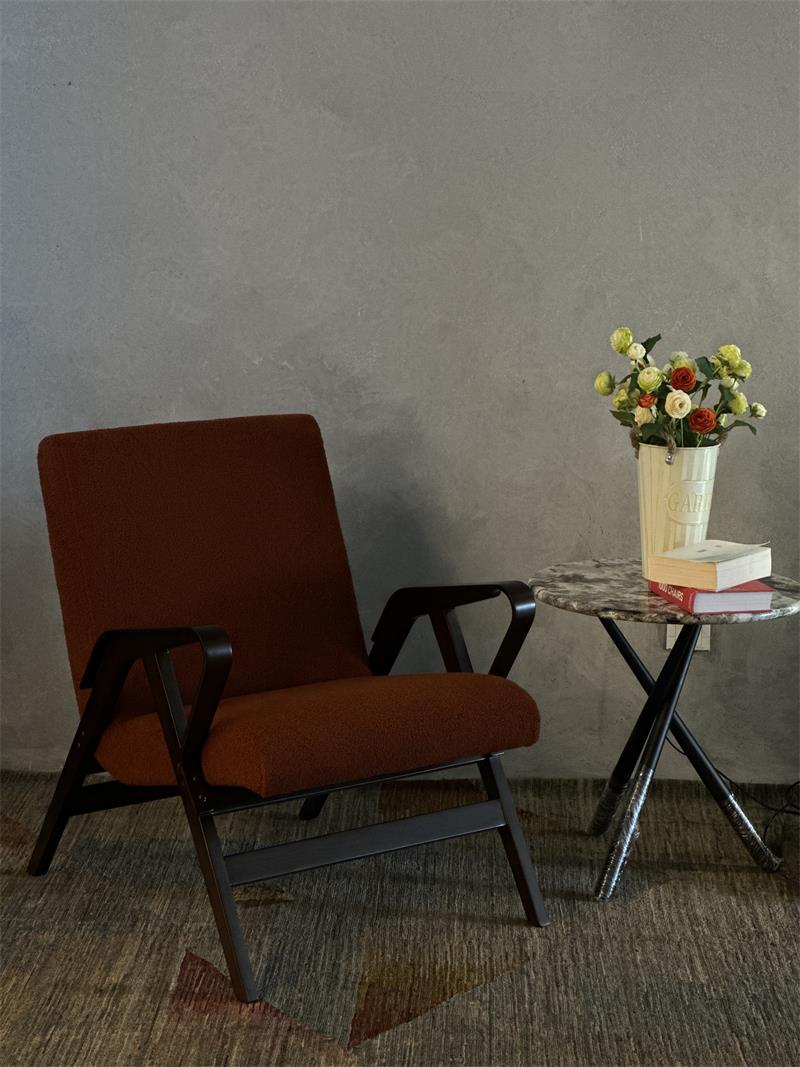 Mid-century industrial style terracotta orange solid wood lounge armchair with soft upholstery