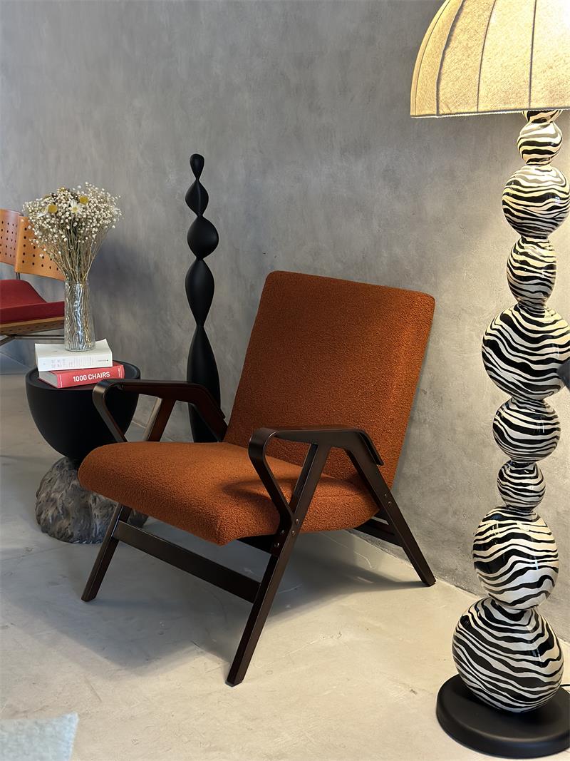 Mid-century industrial style terracotta orange solid wood lounge armchair with soft upholstery