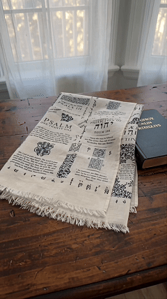 Woman wearing handcrafted prayer shawl printed with Psalms outdoors