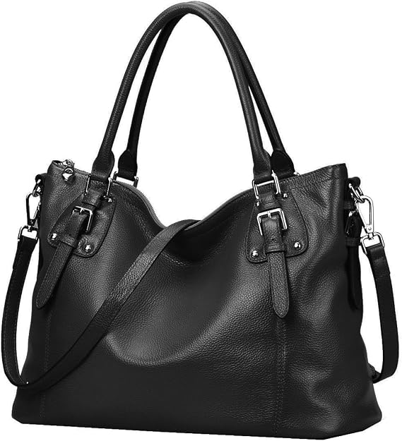 Black leather tote handbag with two top handles, decorative buckle straps on each side, silver-toned hardware, and a removable crossbody strap. Pebbled leather texture with a structured yet soft silhouette.