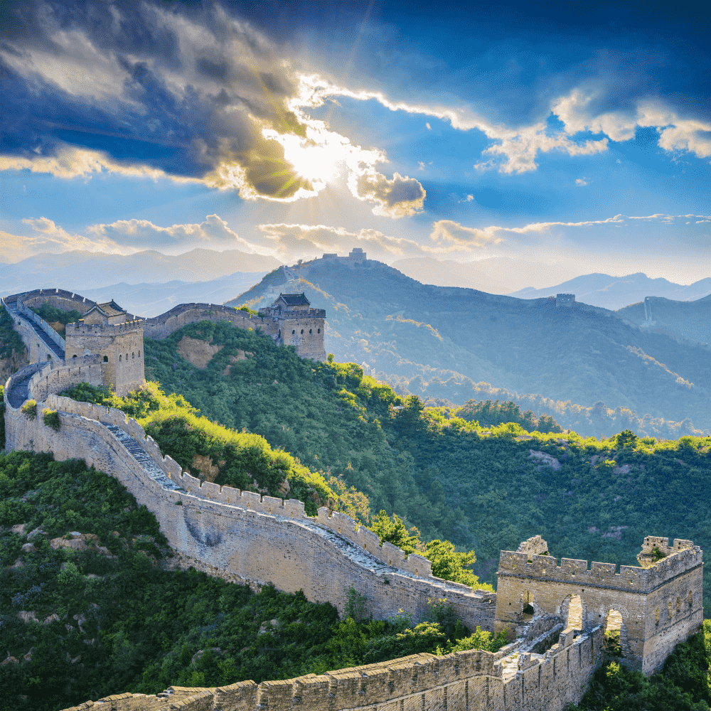 China eSIM – Great Wall of China winding through lush green mountains under dramatic sky, travel eSIM for China
