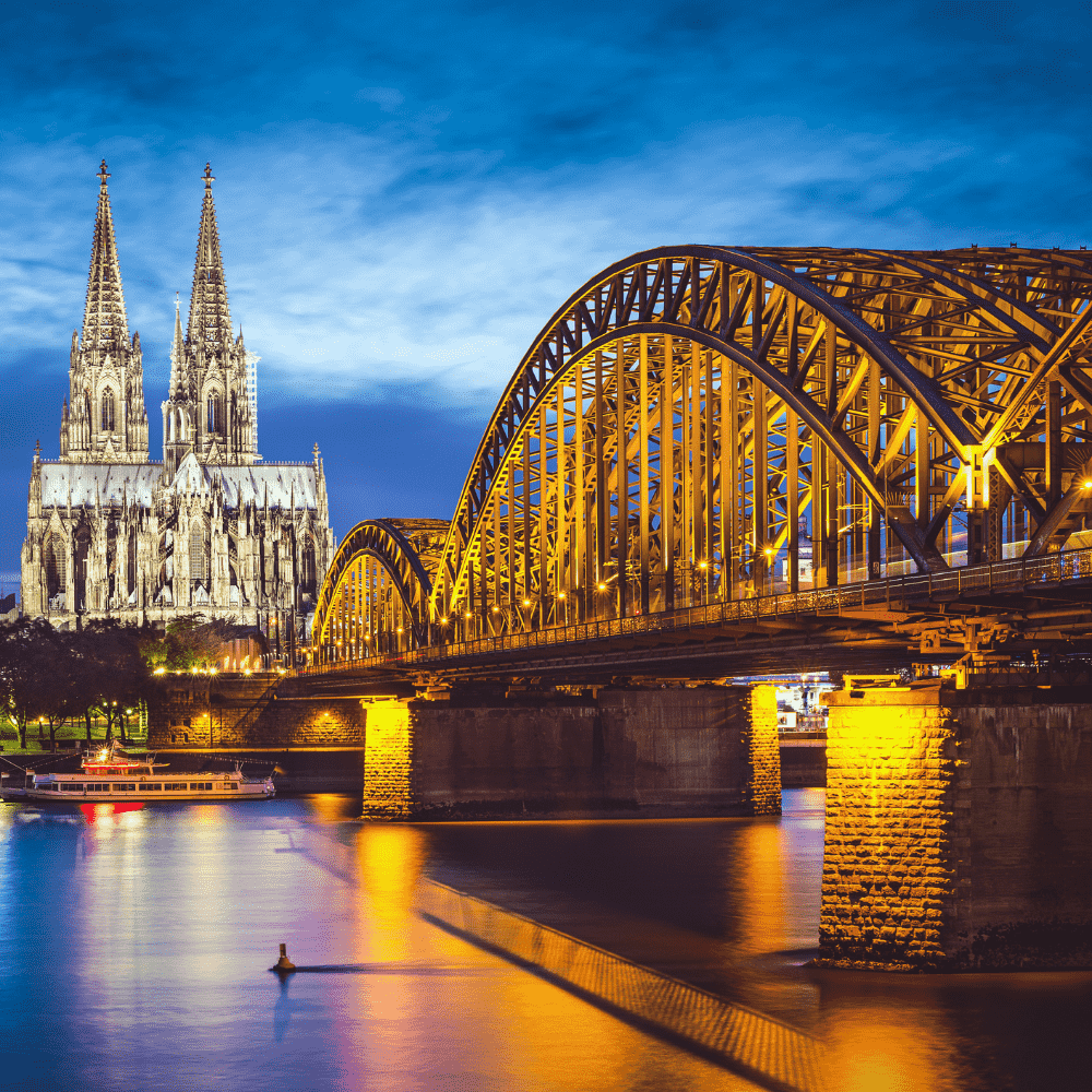 Germany eSIM – Cologne Cathedral and Hohenzollern Bridge illuminated at night, travel eSIM for Germany
