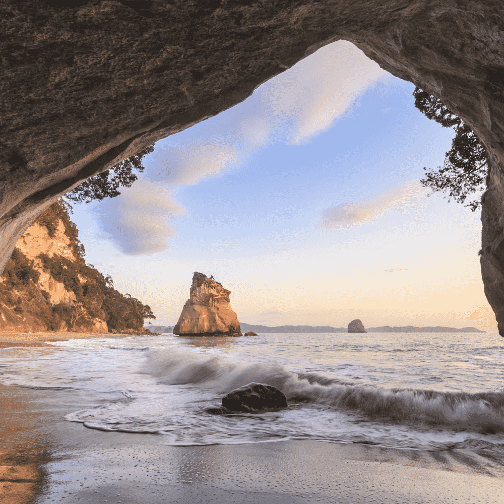 New Zealand eSIM – Cathedral Cove sea arch and coastal rocks at sunset, travel eSIM for New Zealand
