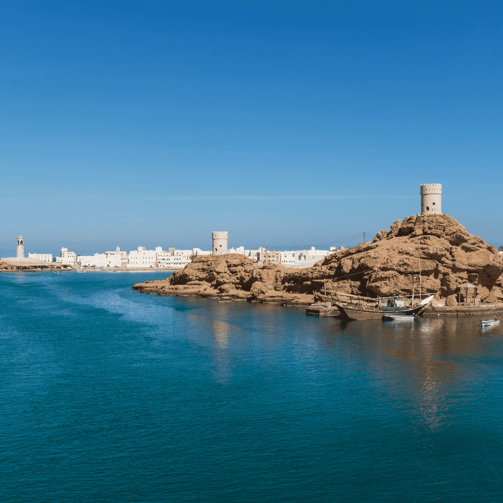 Oman eSIM – Sur coastal watchtower and turquoise bay view, travel eSIM for Oman
