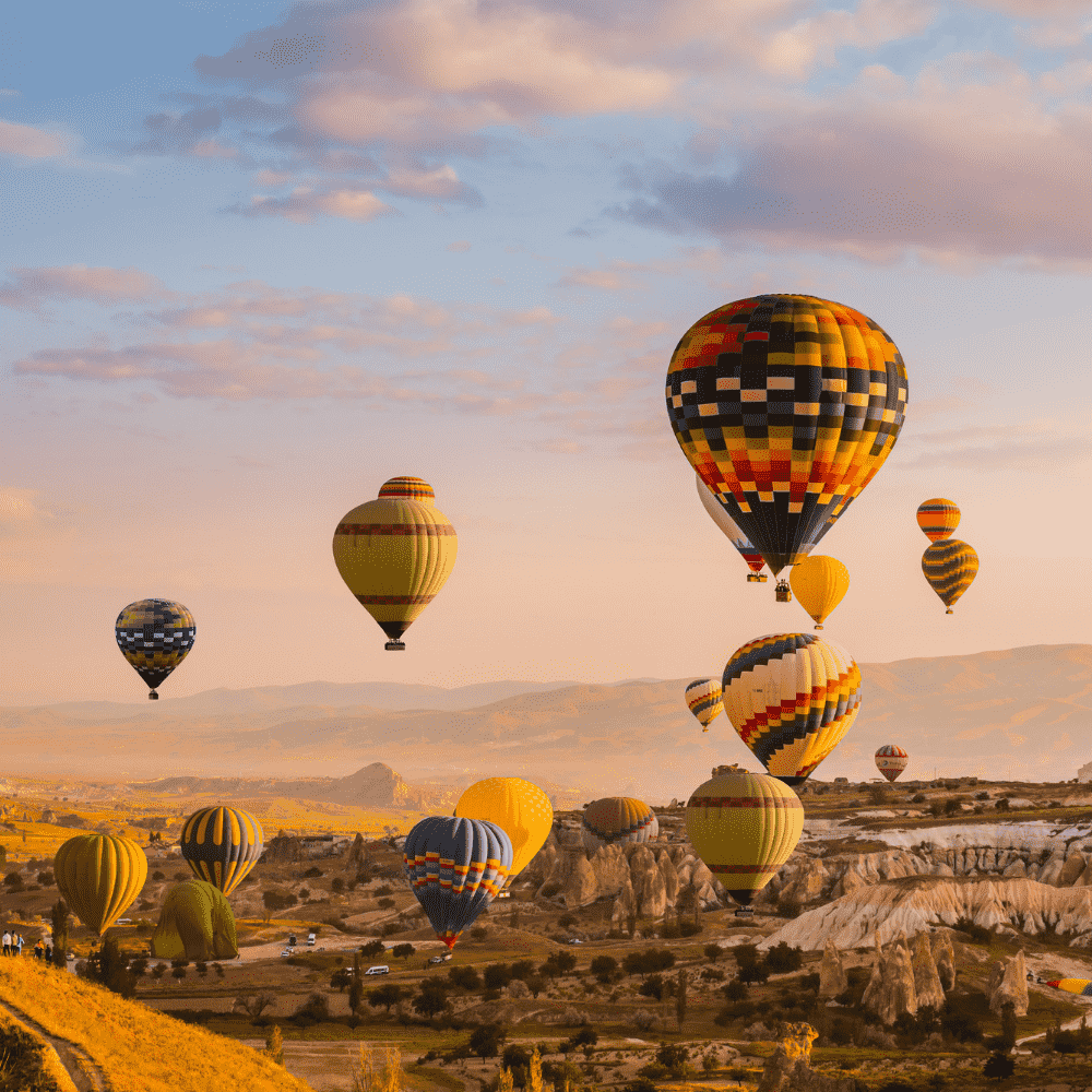 Turkey eSIM – Colorful hot air balloons floating over Cappadocia rock formations at sunrise, travel eSIM for Turkey
