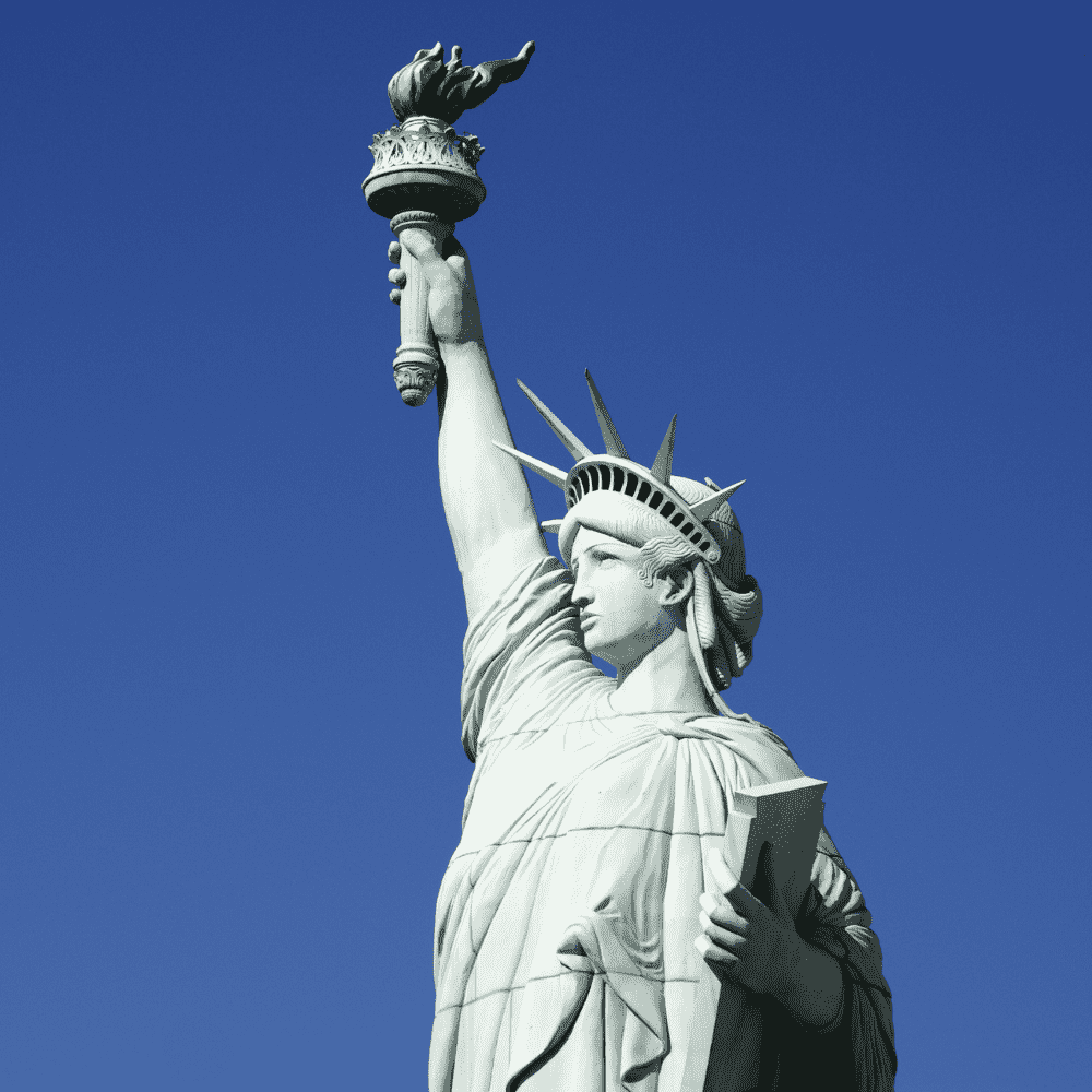 United States eSIM – Statue of Liberty holding torch against clear blue sky in New York, travel eSIM for United States
