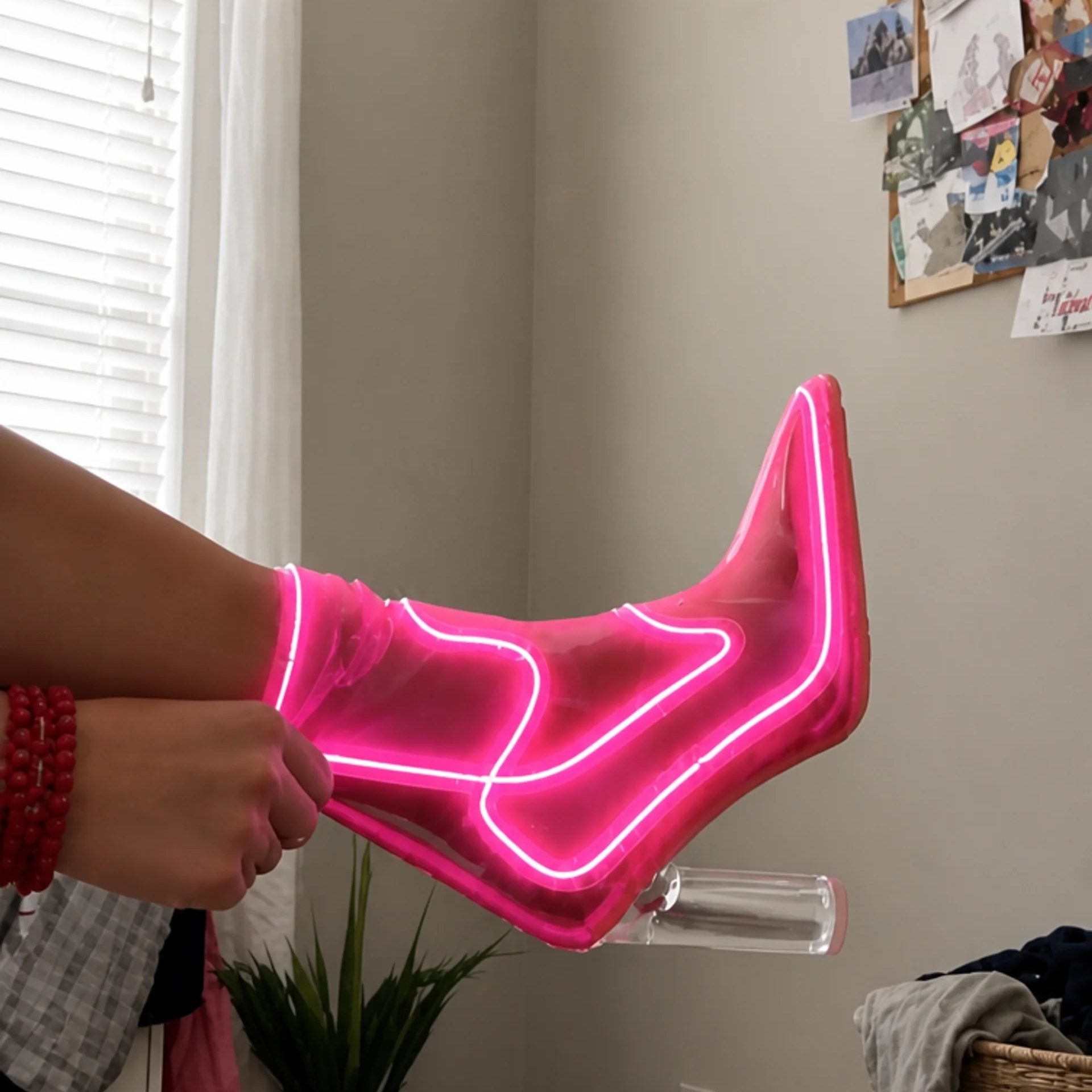 Pink illuminated cowboy boot shown during a real fit check