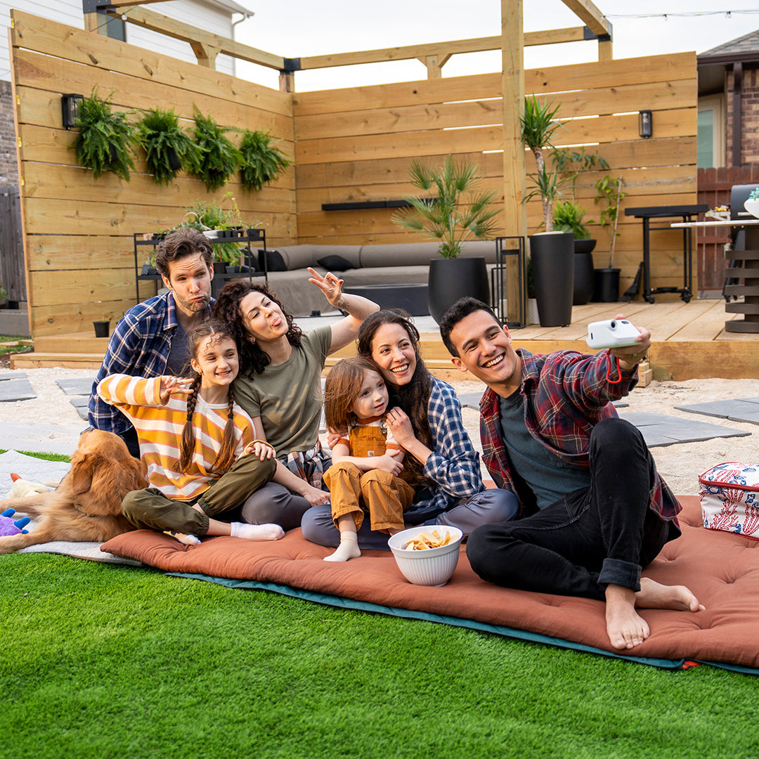 A whole family sit on a floor mattress