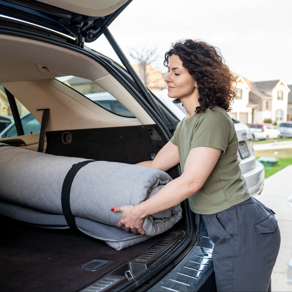 place a roll-up mattress on the car