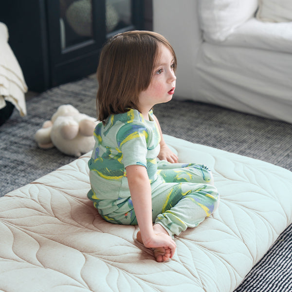kid sit on a floor mattress