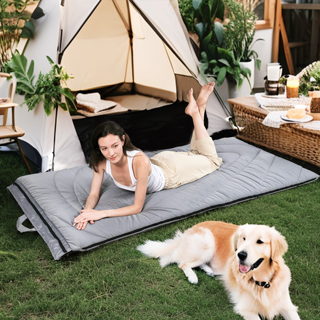 a woman and a dog using zonli outdoor floor mattress