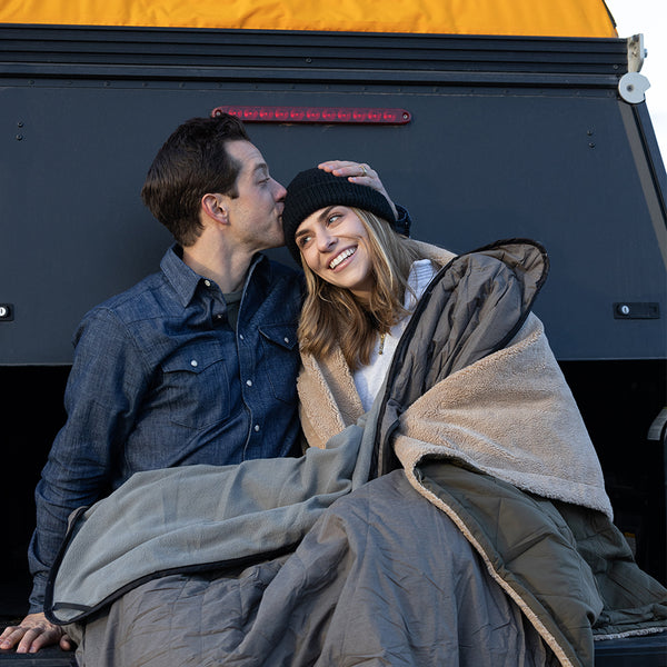 couple camping with blankets