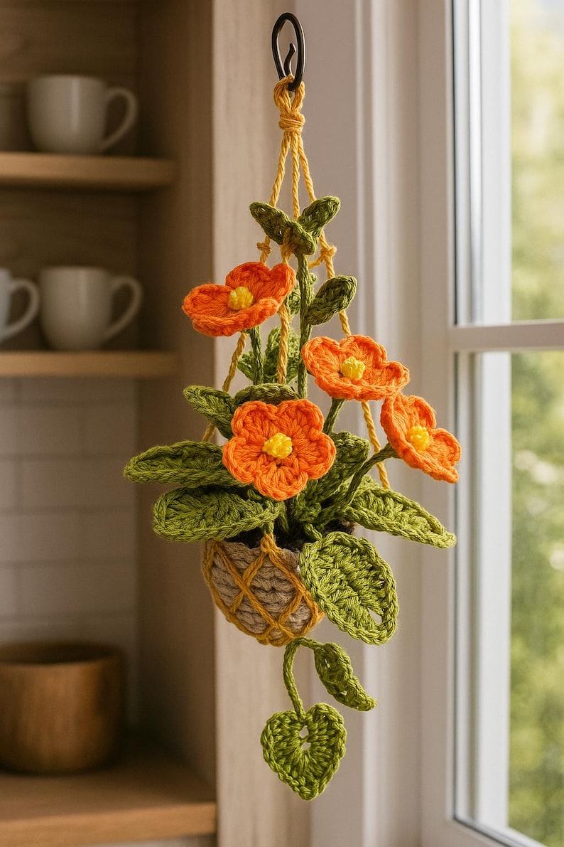 Fleurs au crochet orange amigurumi dans un pot en macramé, plante de fil suspendue faite main, décoration murale florale bohème pour les maisons confortables