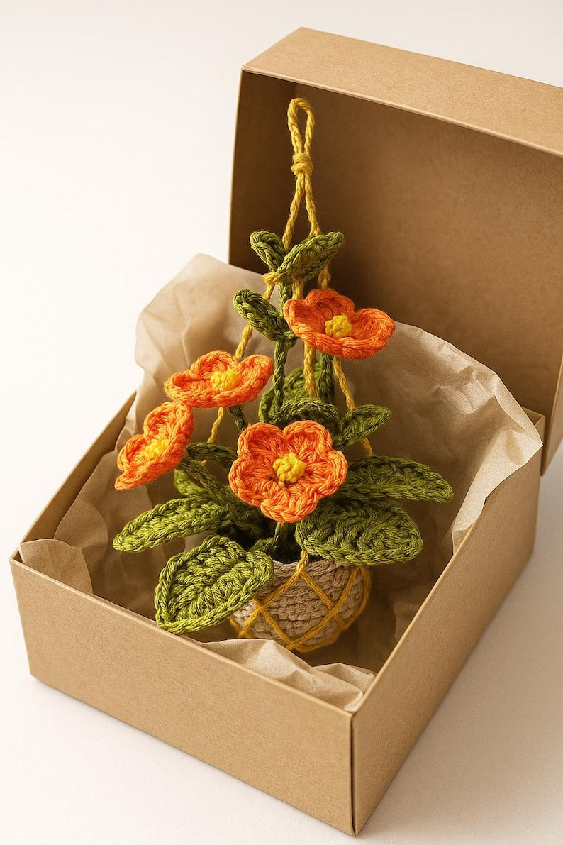 Fleurs au crochet orange amigurumi dans un pot en macramé, plante de fil suspendue faite main, décoration murale florale bohème pour les maisons confortables