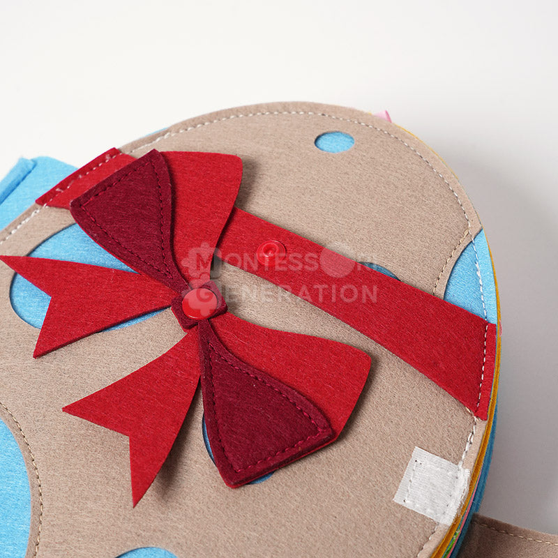 Close up on the front cover of the Montessori Rabbit's Book featuring a cute design and a red felt ribbon.