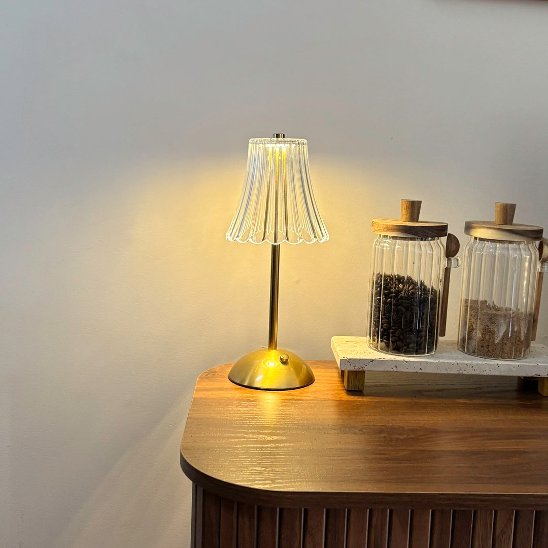 Modern glass table lamp with brass base and ribbed shade