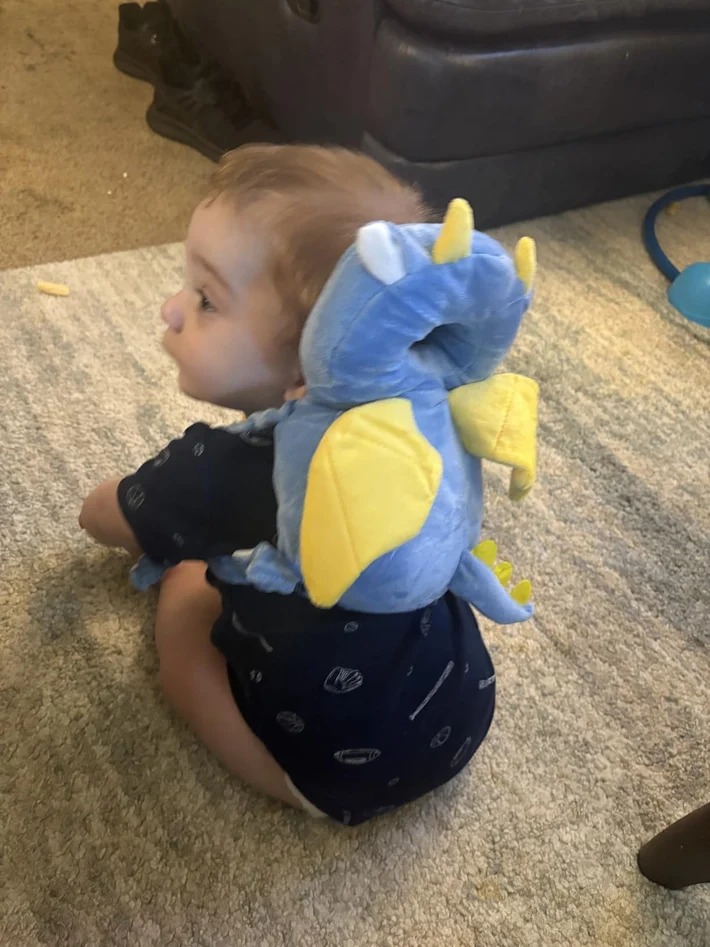 Customer photo of baby wearing the little dragon head protector