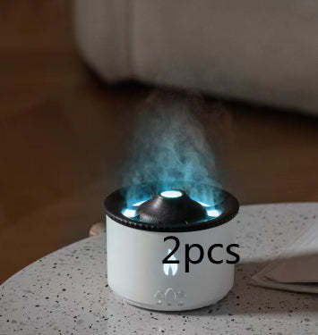 White and black humidifier emitting steam on a speckled surface with '2pcs' text.