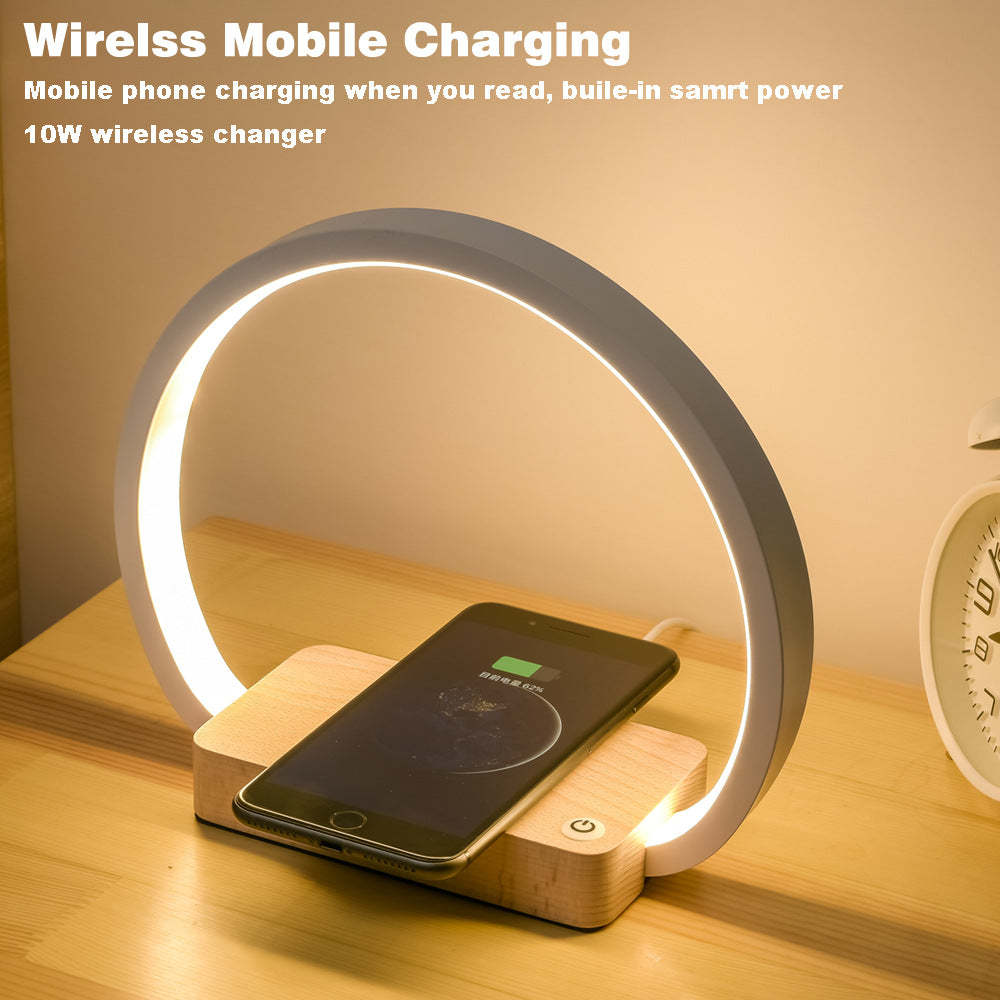 Wireless charging device with a phone on a wooden base, glowing softly.