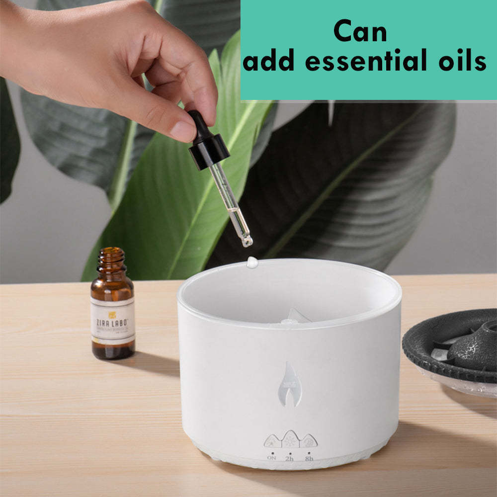 Person adding essential oils to a diffuser with a dropper, surrounded by greenery.