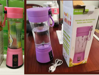 Purple portable juice blender with pink lid on a table next to its packaging