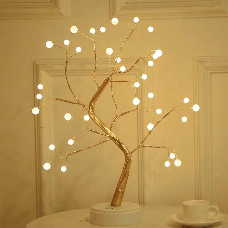Decorative LED tree with lights on a neutral background