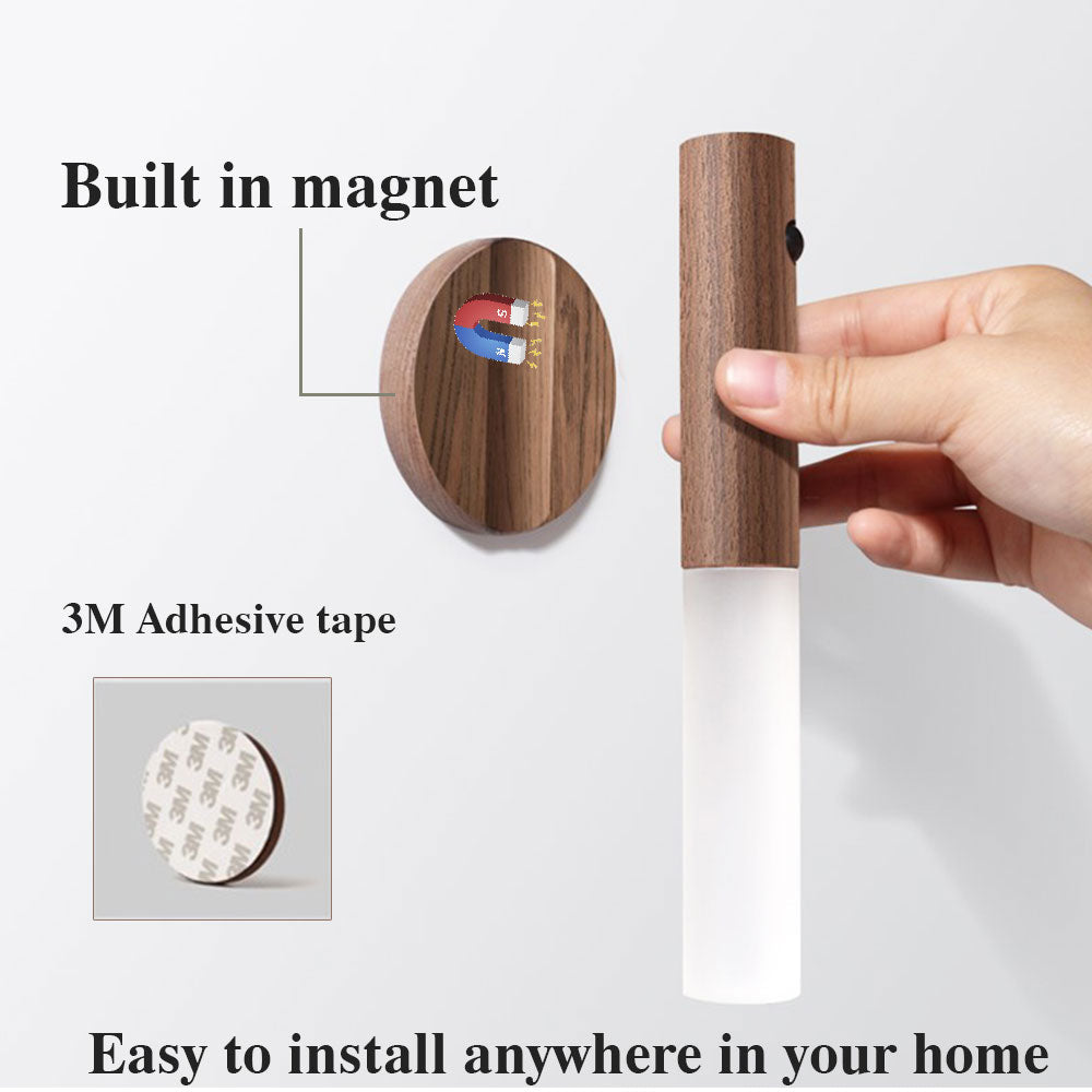 Wooden wall hook with magnetic attachment and adhesive tape, held by a hand.