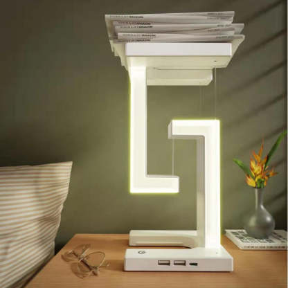 Modern LED table lamp on a wooden surface with books stacked on top, in a room setting.