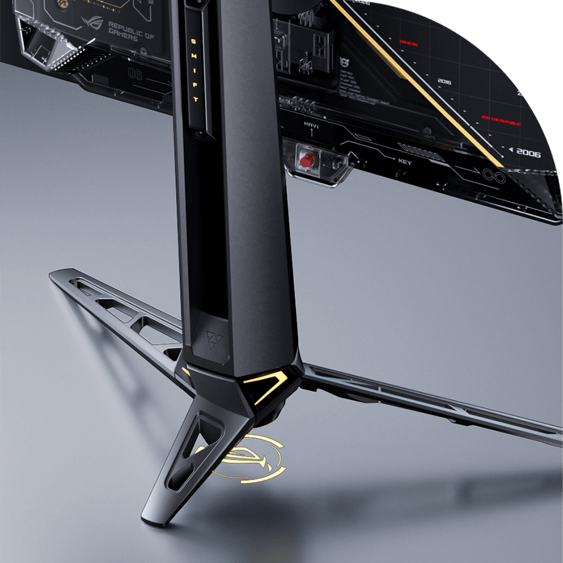 A close-up of the base of a ROG OLED monitor, showcasing its futuristic design with a silver and gray color scheme, angular structure, and blue LED accents