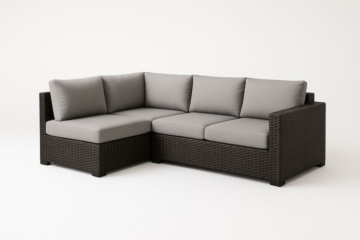 Narożna sofa z technorattanu z szarymi poduszkami