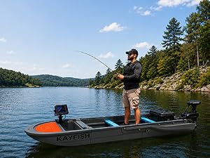 Angler standing and fishing from a modular fishing boat on a lake.